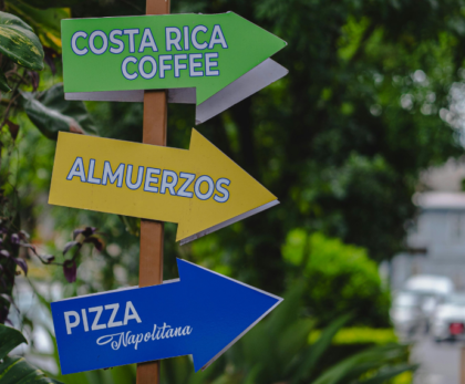 Directional signpost for Costa Rica coffee, lunch, and sodas