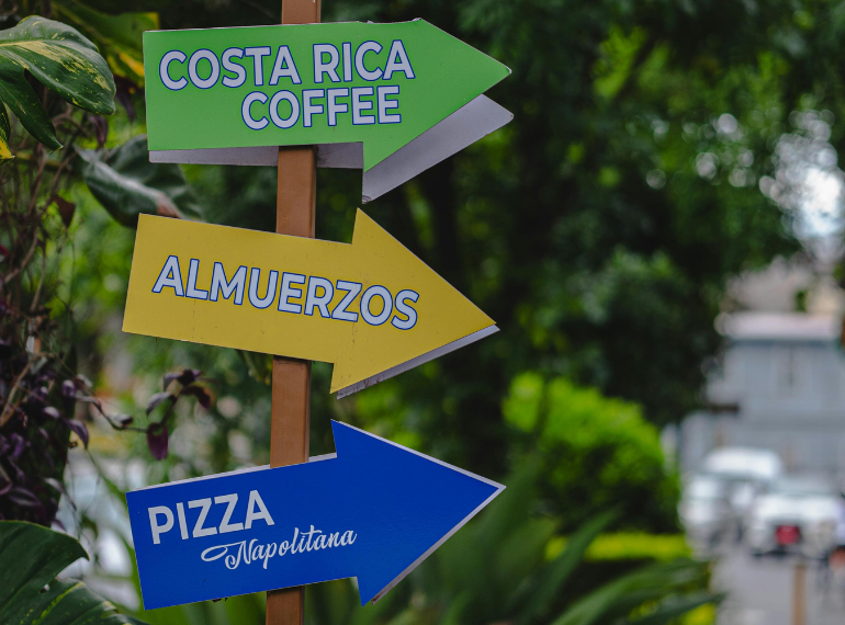 Directional signpost for Costa Rica coffee, lunch, and sodas